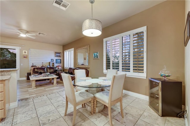 dining space with a ceiling fan, visible vents, and baseboards