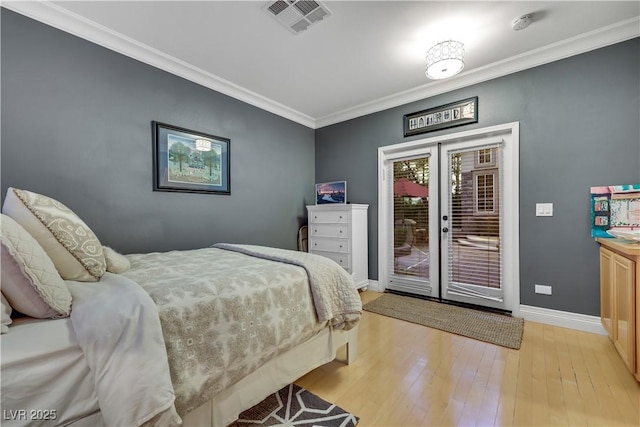 bedroom with visible vents, light wood-style floors, access to outside, french doors, and ornamental molding