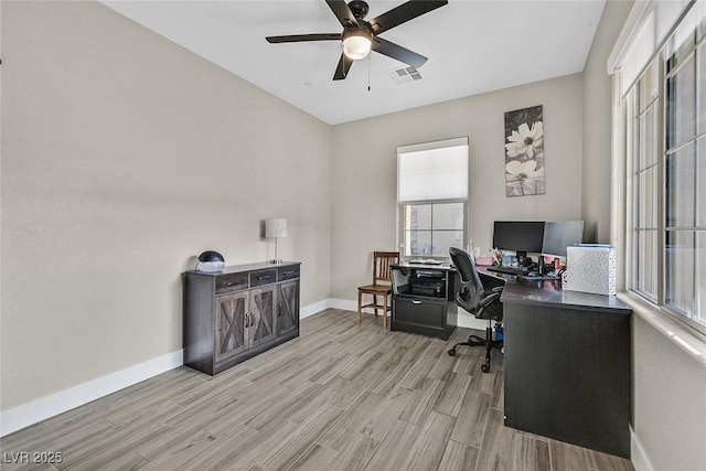 home office with visible vents, ceiling fan, baseboards, and wood finished floors