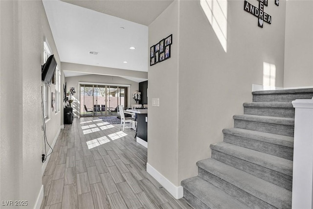 staircase featuring baseboards, recessed lighting, visible vents, and wood tiled floor