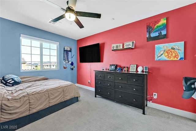 bedroom with carpet floors, visible vents, baseboards, and a ceiling fan