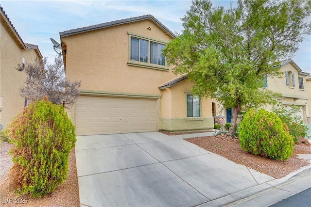 traditional home featuring concrete driveway, an attached garage, a tile roof, and stucco siding