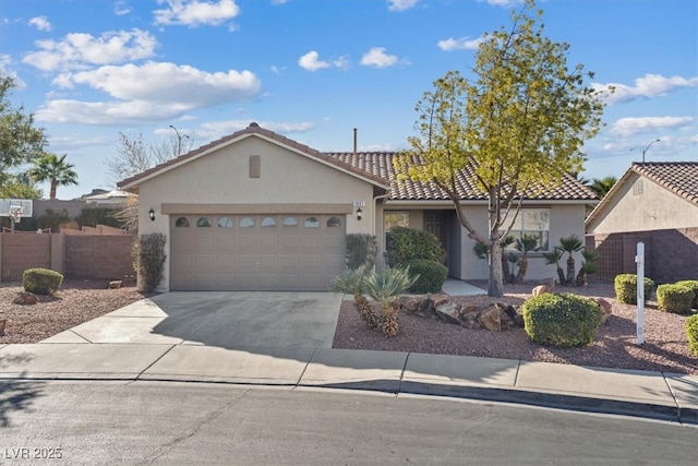 view of front of property with concrete driveway, an attached garage, fence, and stucco siding