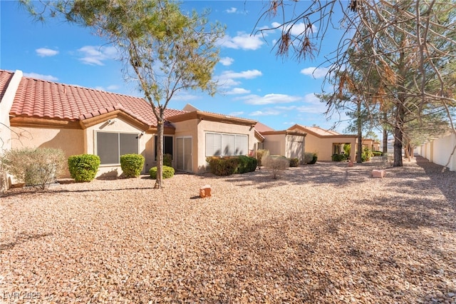 view of front of home featuring a tile roof and stucco siding