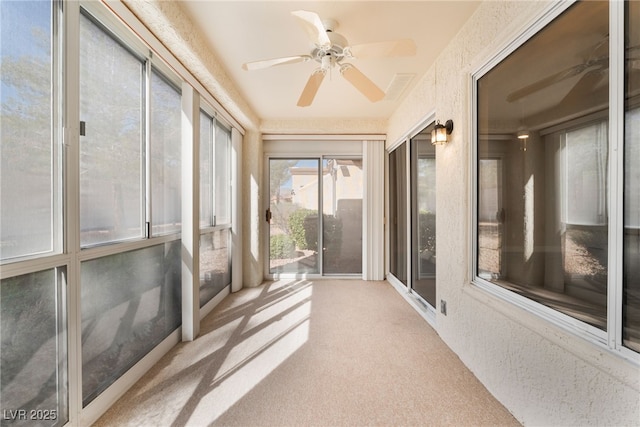 sunroom / solarium with ceiling fan