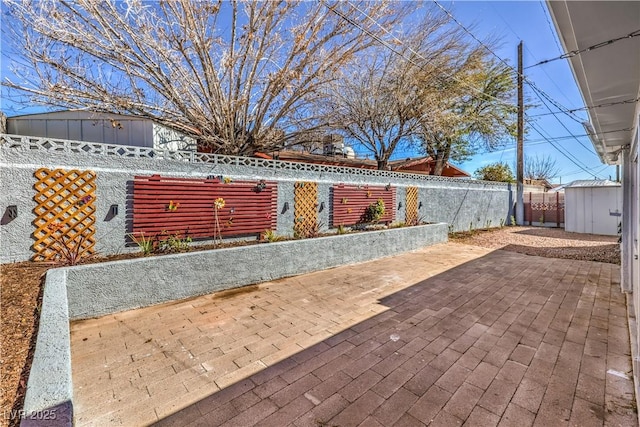 view of patio with fence private yard and an outdoor structure