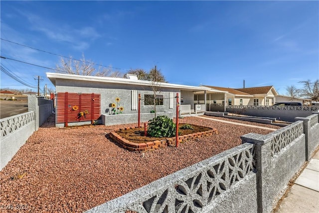 ranch-style house with fence and stucco siding