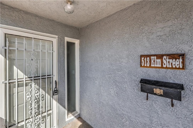 property entrance with stucco siding