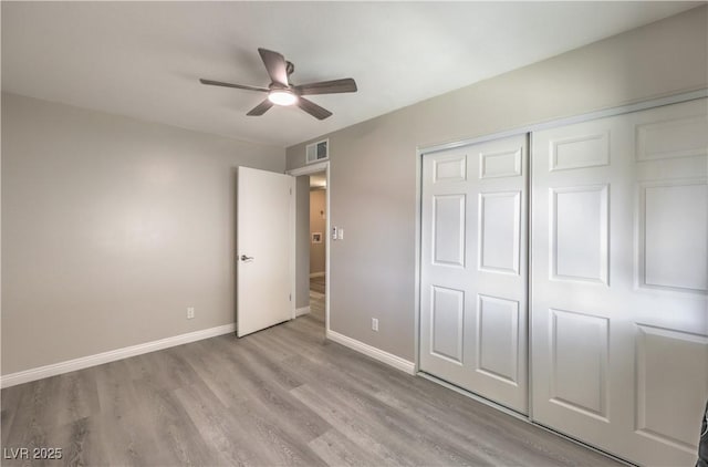 unfurnished bedroom with visible vents, baseboards, ceiling fan, light wood-style floors, and a closet