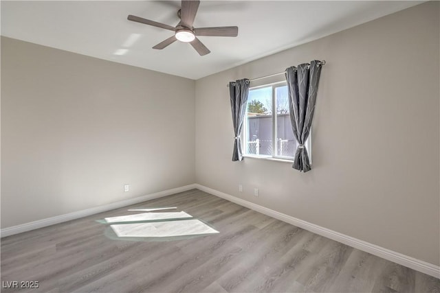 unfurnished room with ceiling fan, baseboards, and wood finished floors