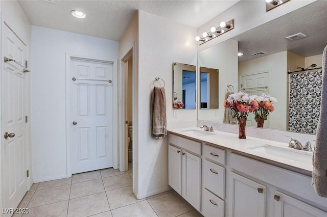 full bath featuring a sink, visible vents, and tile patterned floors