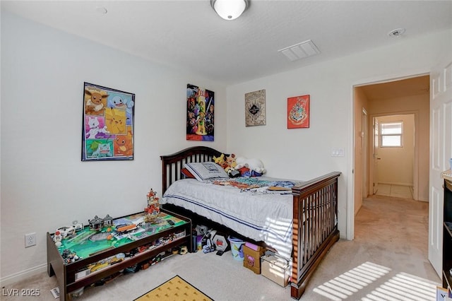 bedroom with visible vents and light colored carpet