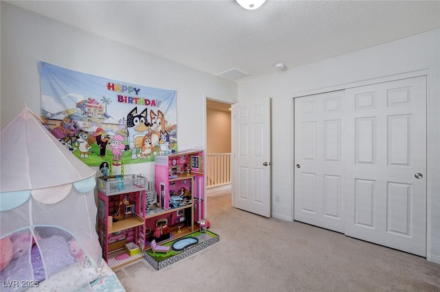 rec room with carpet and a textured ceiling