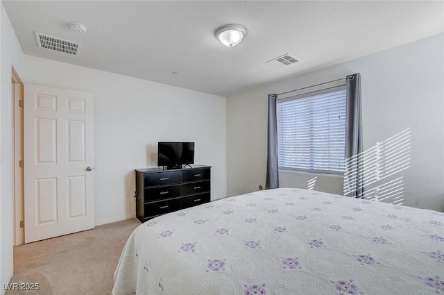 carpeted bedroom featuring baseboards and visible vents