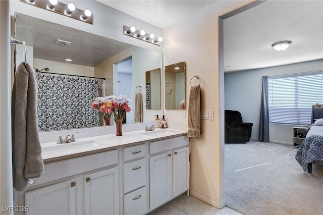 bathroom featuring double vanity, a shower with shower curtain, a sink, and visible vents