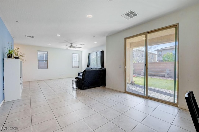 unfurnished living room featuring visible vents and light tile patterned flooring