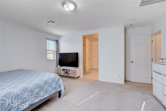 bedroom featuring visible vents and light colored carpet