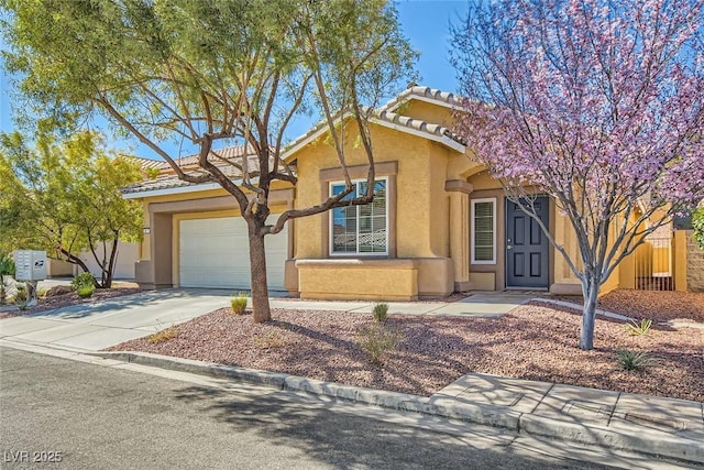 view of front of home featuring concrete driveway, a tiled roof, an attached garage, and stucco siding