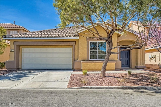 view of front of house featuring a garage, concrete driveway, a tiled roof, and stucco siding