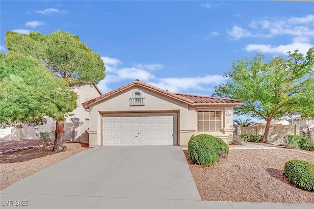 mediterranean / spanish-style house with a garage, a tiled roof, concrete driveway, and stucco siding