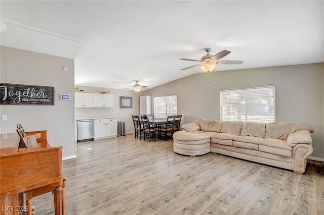 living room with lofted ceiling, baseboards, ceiling fan, and light wood finished floors