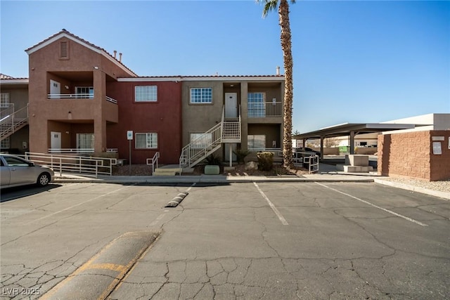 view of property featuring uncovered parking