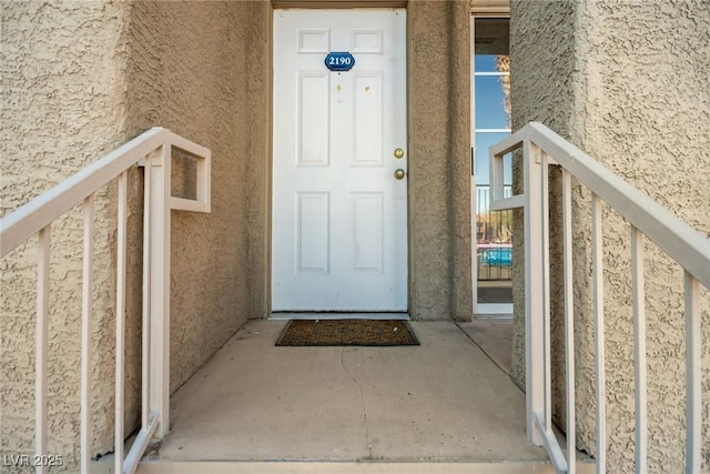 entrance to property with stucco siding