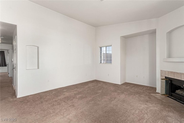 unfurnished living room featuring carpet and a fireplace