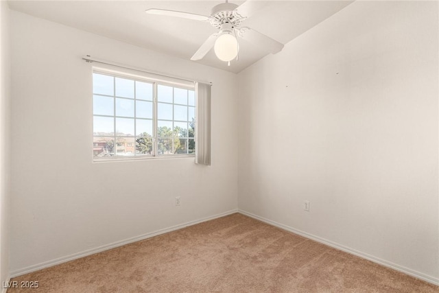 carpeted empty room with ceiling fan and baseboards