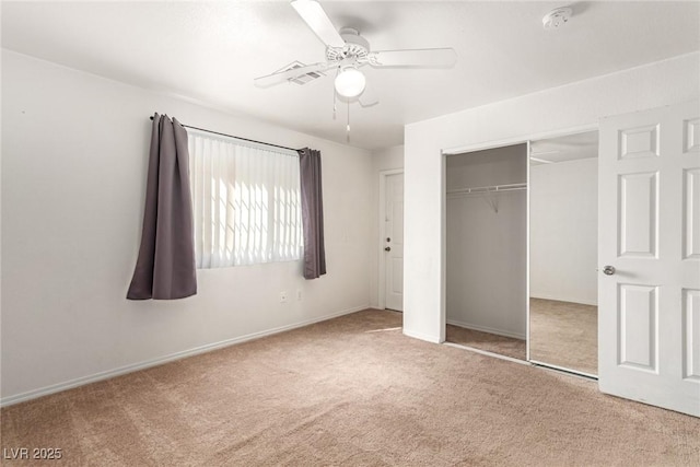 unfurnished bedroom with carpet floors, a closet, ceiling fan, and baseboards