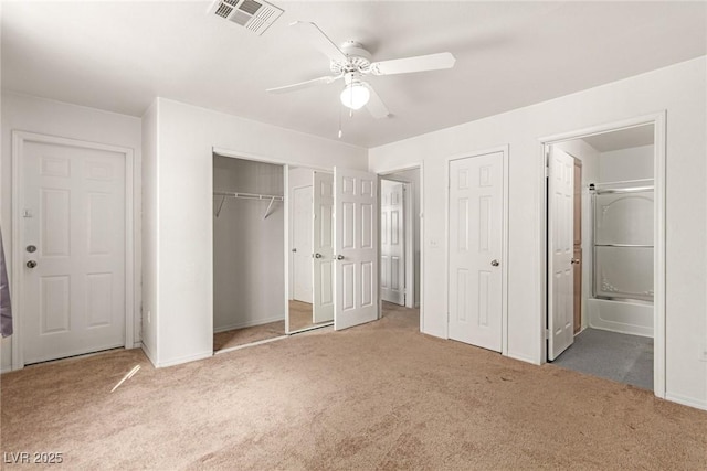 unfurnished bedroom featuring carpet floors, connected bathroom, visible vents, and a ceiling fan