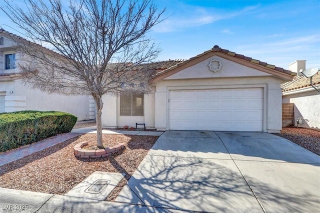 ranch-style home with driveway, an attached garage, a tiled roof, and stucco siding