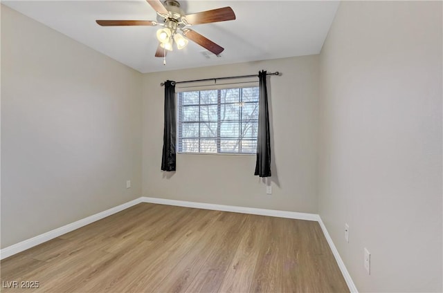 unfurnished room featuring ceiling fan, light wood-style flooring, and baseboards