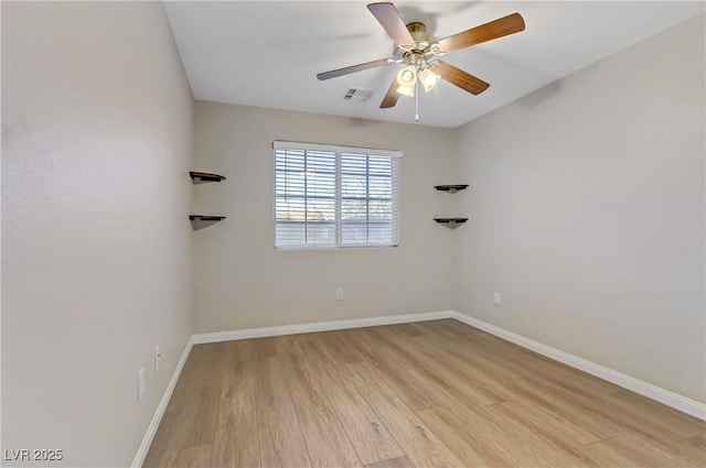 unfurnished room with light wood-style flooring, a ceiling fan, visible vents, and baseboards