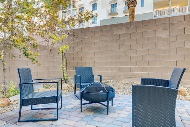 view of patio with a fenced backyard and a fire pit