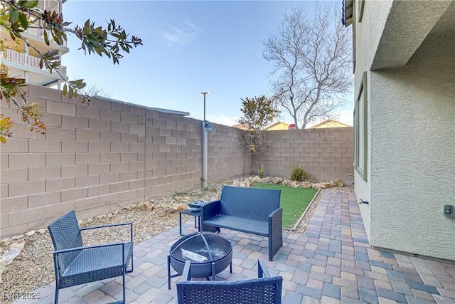 view of patio / terrace with a fire pit and a fenced backyard