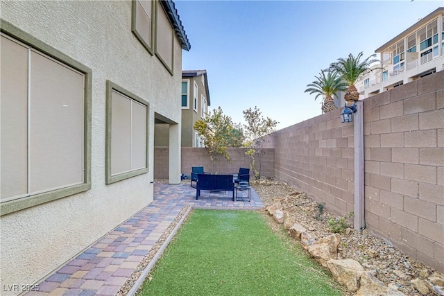 view of yard with a patio area, a fenced backyard, and outdoor lounge area