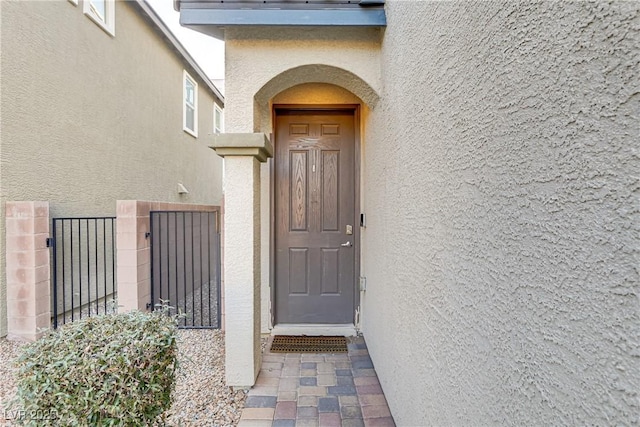 view of exterior entry with stucco siding