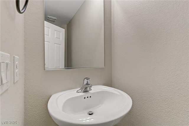 bathroom with a sink and visible vents