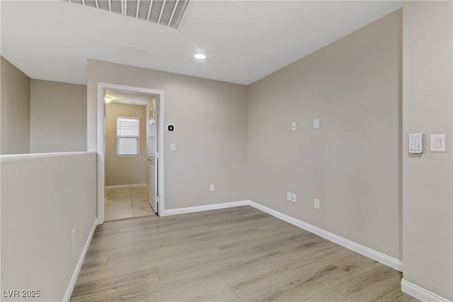 unfurnished room featuring baseboards, recessed lighting, visible vents, and light wood-style floors