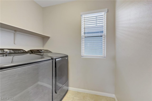 laundry room featuring light tile patterned floors, laundry area, independent washer and dryer, and baseboards