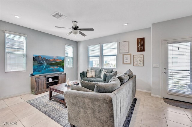 living area with light tile patterned floors, recessed lighting, visible vents, baseboards, and a ceiling fan