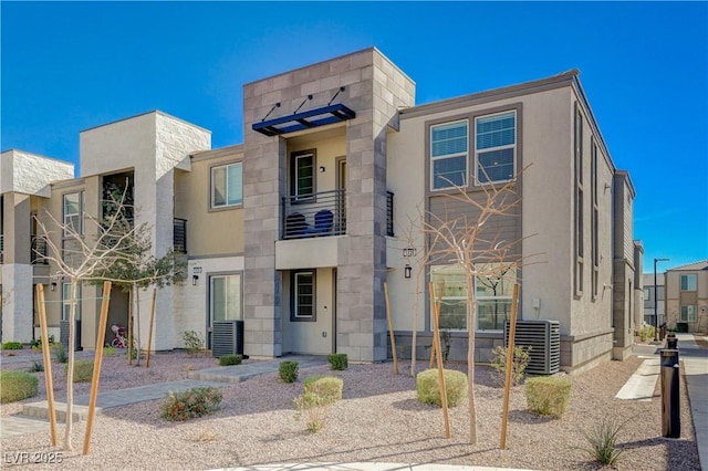 view of front of home featuring central AC and stucco siding