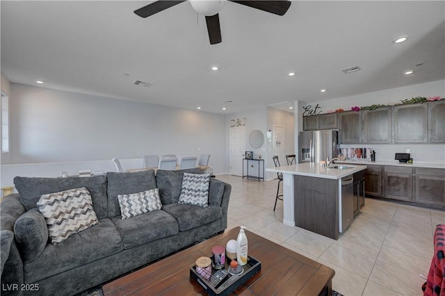 living area featuring a ceiling fan, light tile patterned flooring, visible vents, and recessed lighting