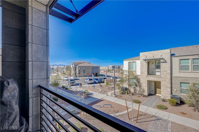 balcony featuring central AC unit, area for grilling, and a residential view