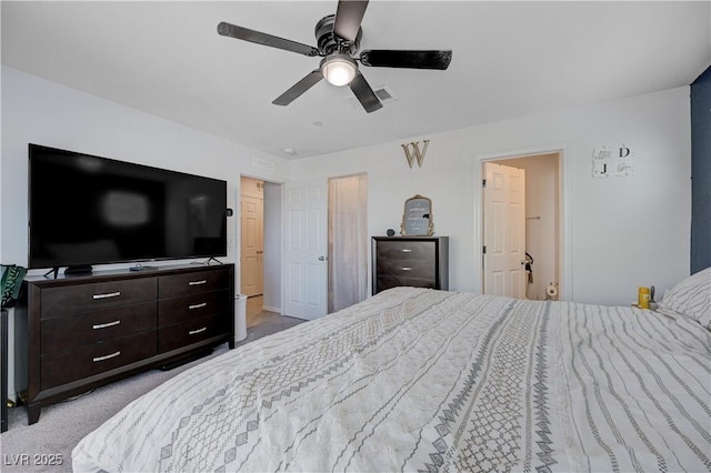 bedroom with ceiling fan, visible vents, and light colored carpet