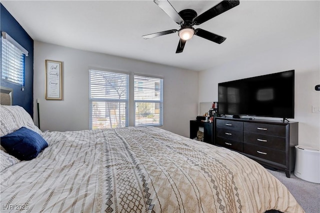 bedroom featuring carpet flooring, ceiling fan, and multiple windows