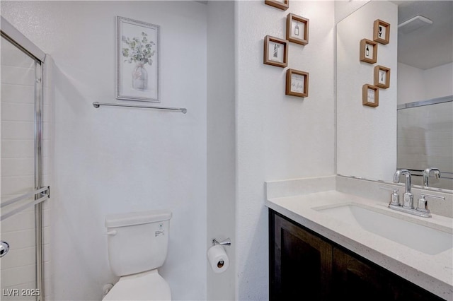 bathroom featuring walk in shower, vanity, and toilet