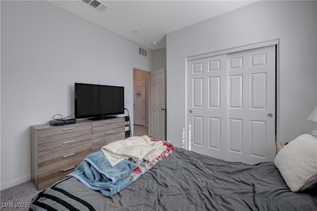 carpeted bedroom featuring baseboards, visible vents, and a closet