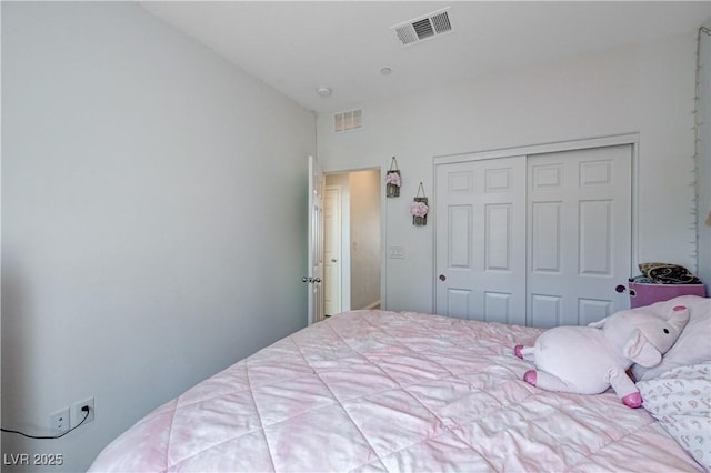 bedroom with visible vents and a closet